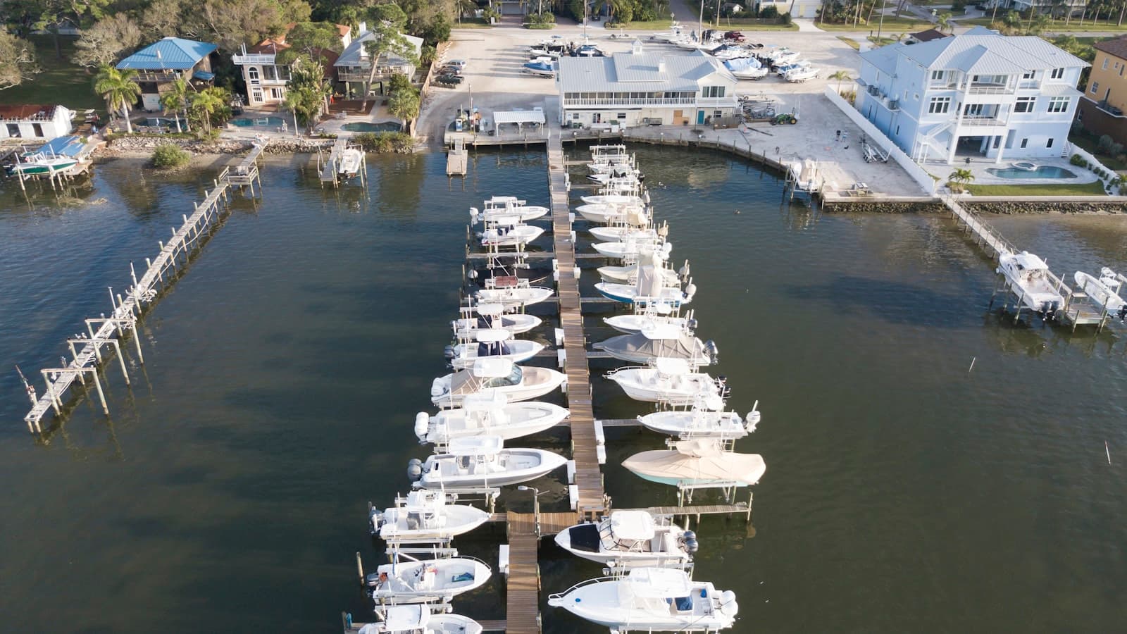aerial view of white motorboats on calm body of water