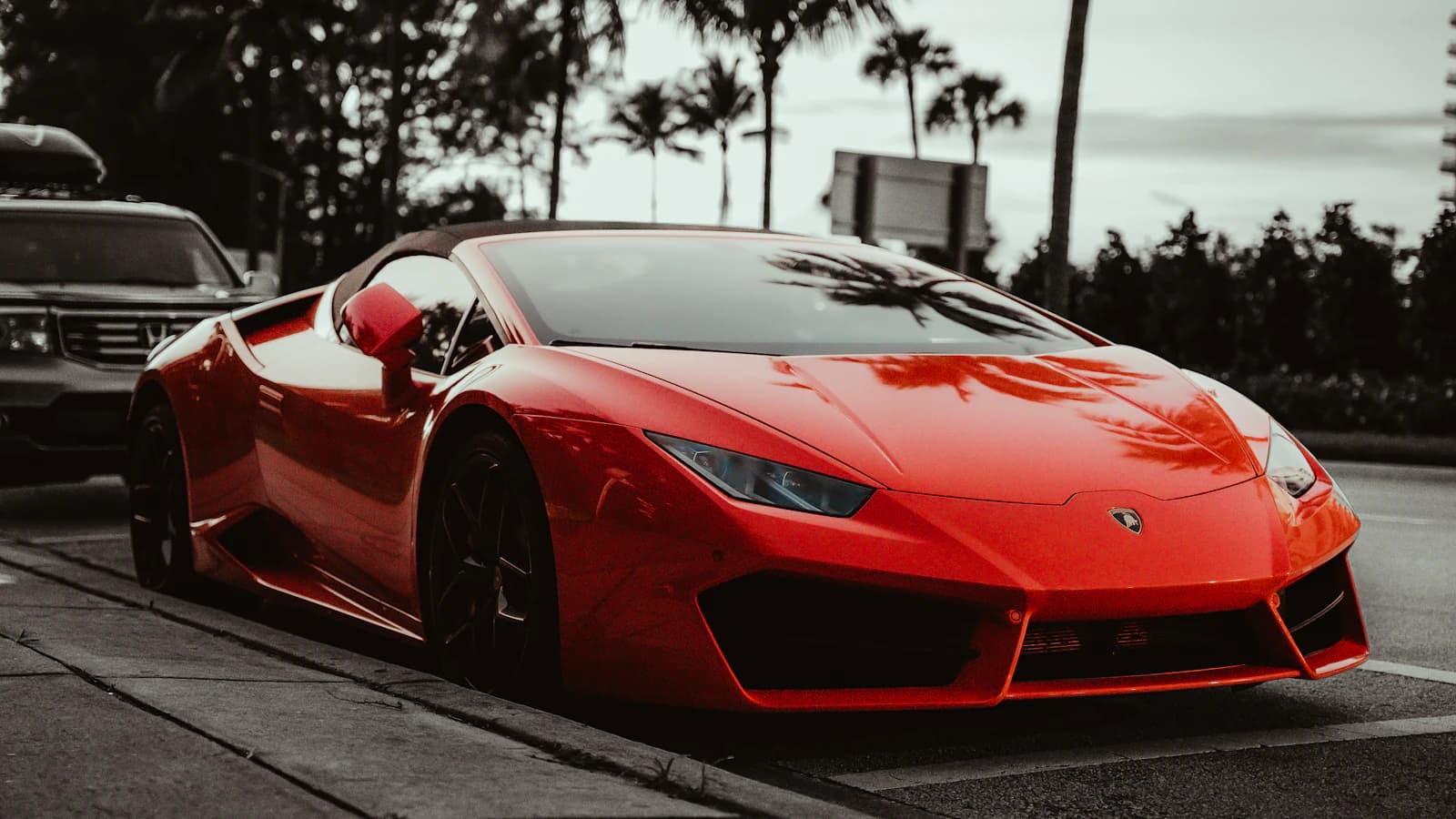 A red sports car parked along a South Florida street